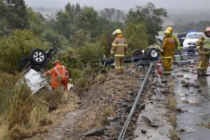 A ute carrying another ute on a trailer crashed into two sets of wire rope barriers on the Calder Freeway at Taradale before flipping and landing in a gully. Photo: IET Systems